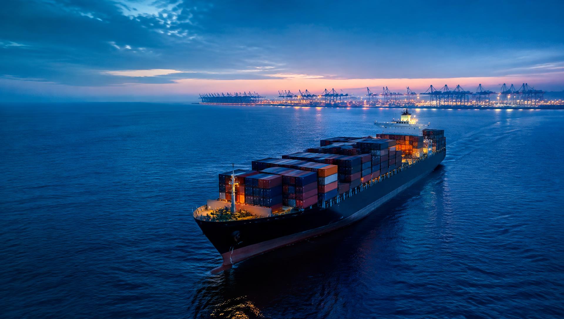 Cargo ship carrying containers toward a port